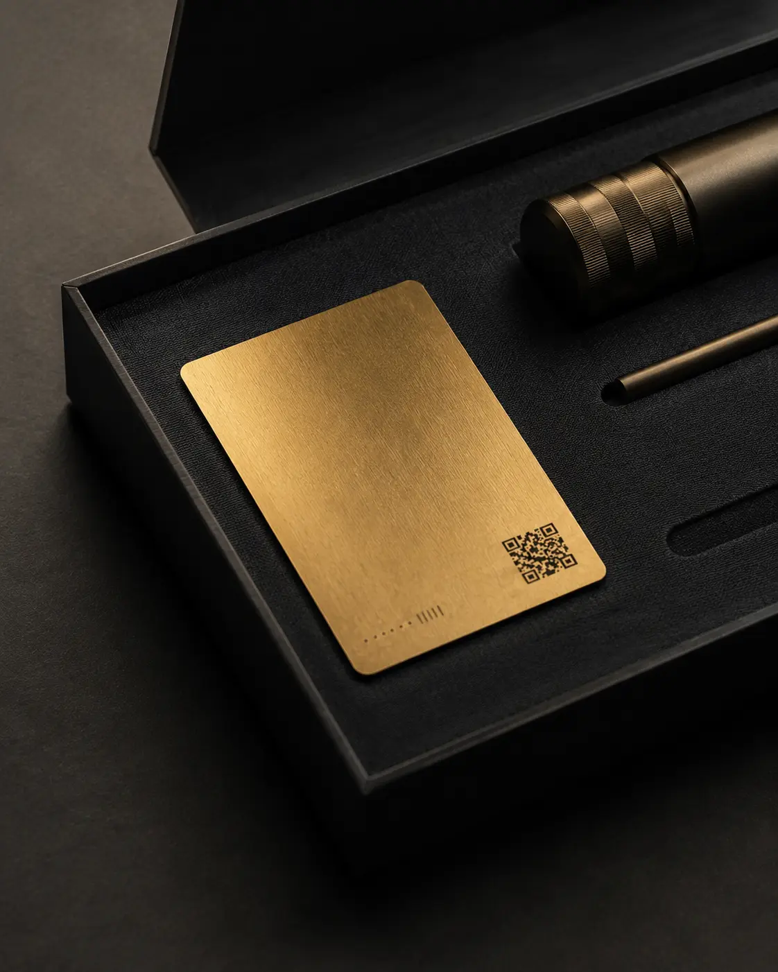 A thin gold warranty card presented with an anonymous precision object